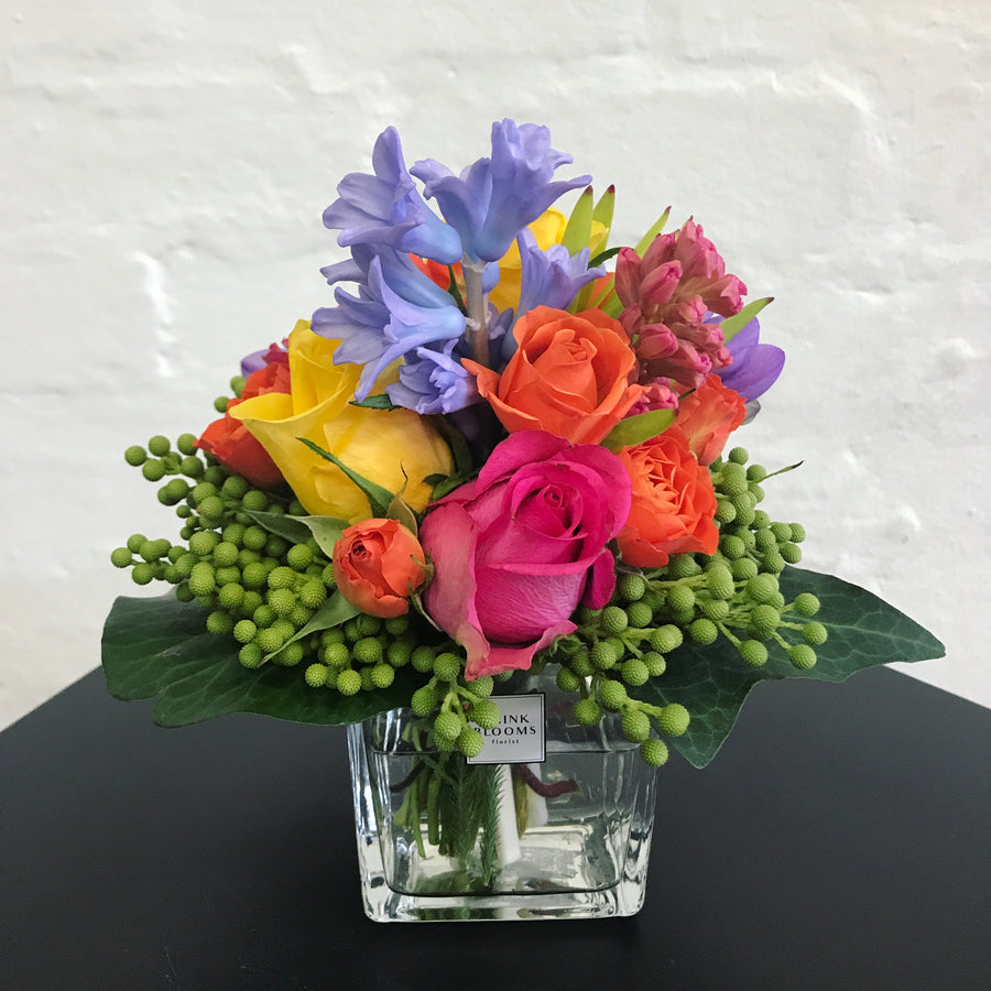 colorful fresh little posy in vase with bright color roses and other seasonal fresh flowers